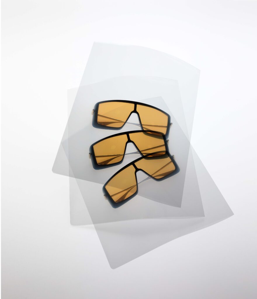 Minimalist flat lay of designer sunglasses representing Esquire Middle East men’s fashion and luxury accessories.