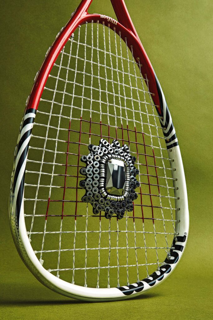 Close-up of a tennis racket resting on a court surface representing Esquire Middle East men’s sports and lifestyle culture.