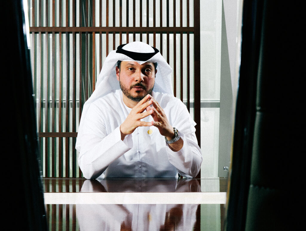 Middle Eastern business executive in traditional attire seated at a desk featured in Arabian Business.