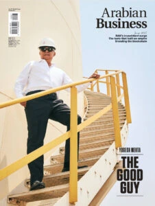 Arabian Business cover featuring construction industry leader on site.