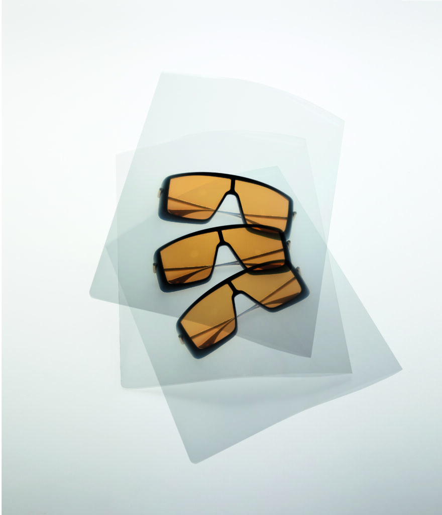 Minimalist flat lay of designer sunglasses representing Esquire Middle East men’s fashion and accessory trends.