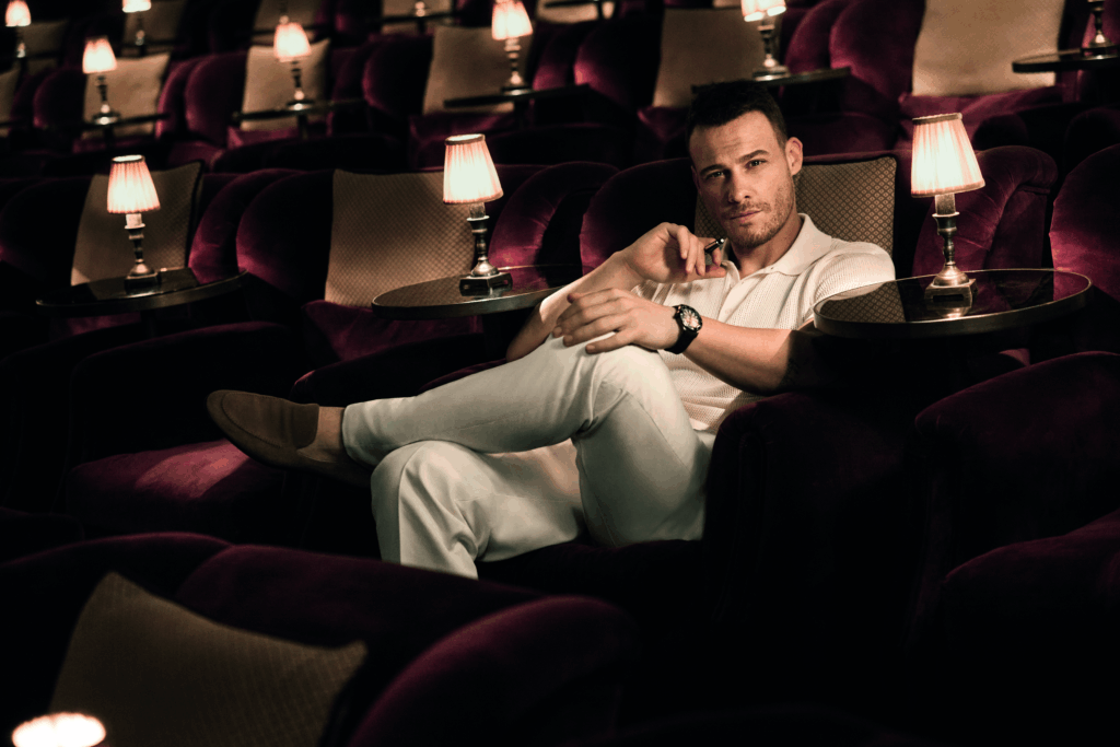 Esquire Middle East cover featuring a male celebrity seated in a luxury cinema setting wearing a modern neutral outfit and wristwatch.