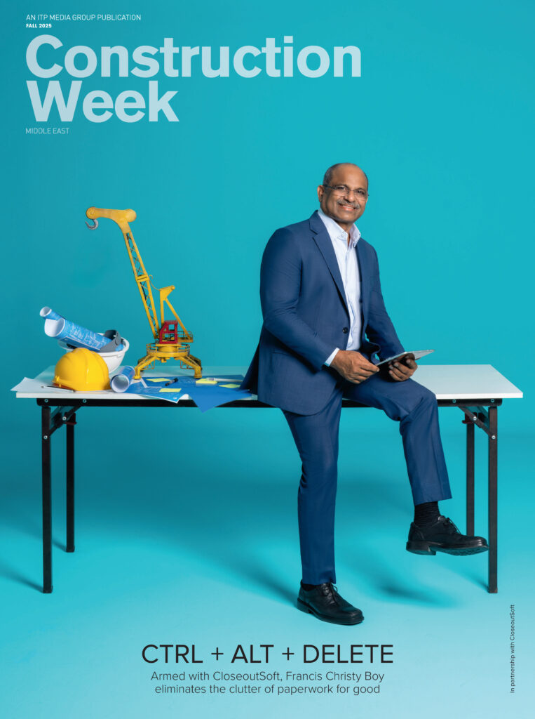 Construction Week magazine cover featuring a construction executive seated on a stool against a blue background.