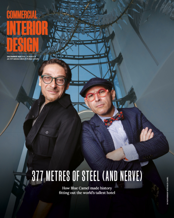 A magazine cover featuring two men wearing dark outfits and glasses, standing side by side against a blue-toned background.