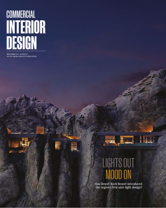 A magazine cover displaying a dramatic mountainous landscape with architectural structures illuminated at dusk.