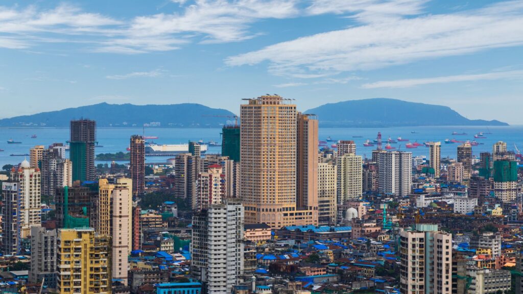 City skyline in India with high-rise buildings and coastal backdrop, representing Construction Week India’s coverage of infrastructure and development.