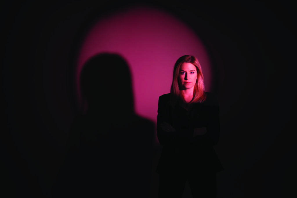 Senior construction industry executive standing against a warm studio backdrop, representing leadership in the Middle East built environment sector.