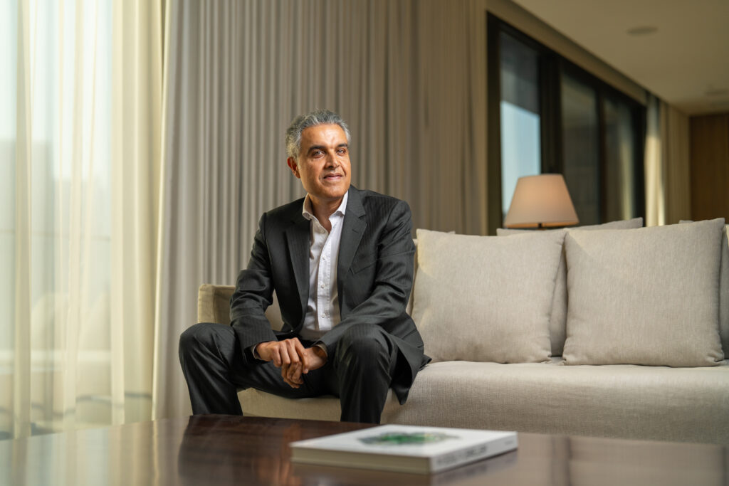 Ajay Bhatia seated in a modern office setting, representing leadership coverage by Construction Week Middle East.