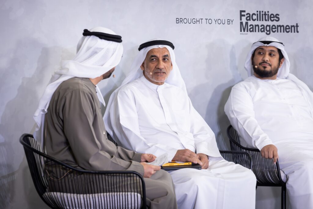 Industry professionals in traditional and business attire attending a Facilities Management Middle East leadership event.