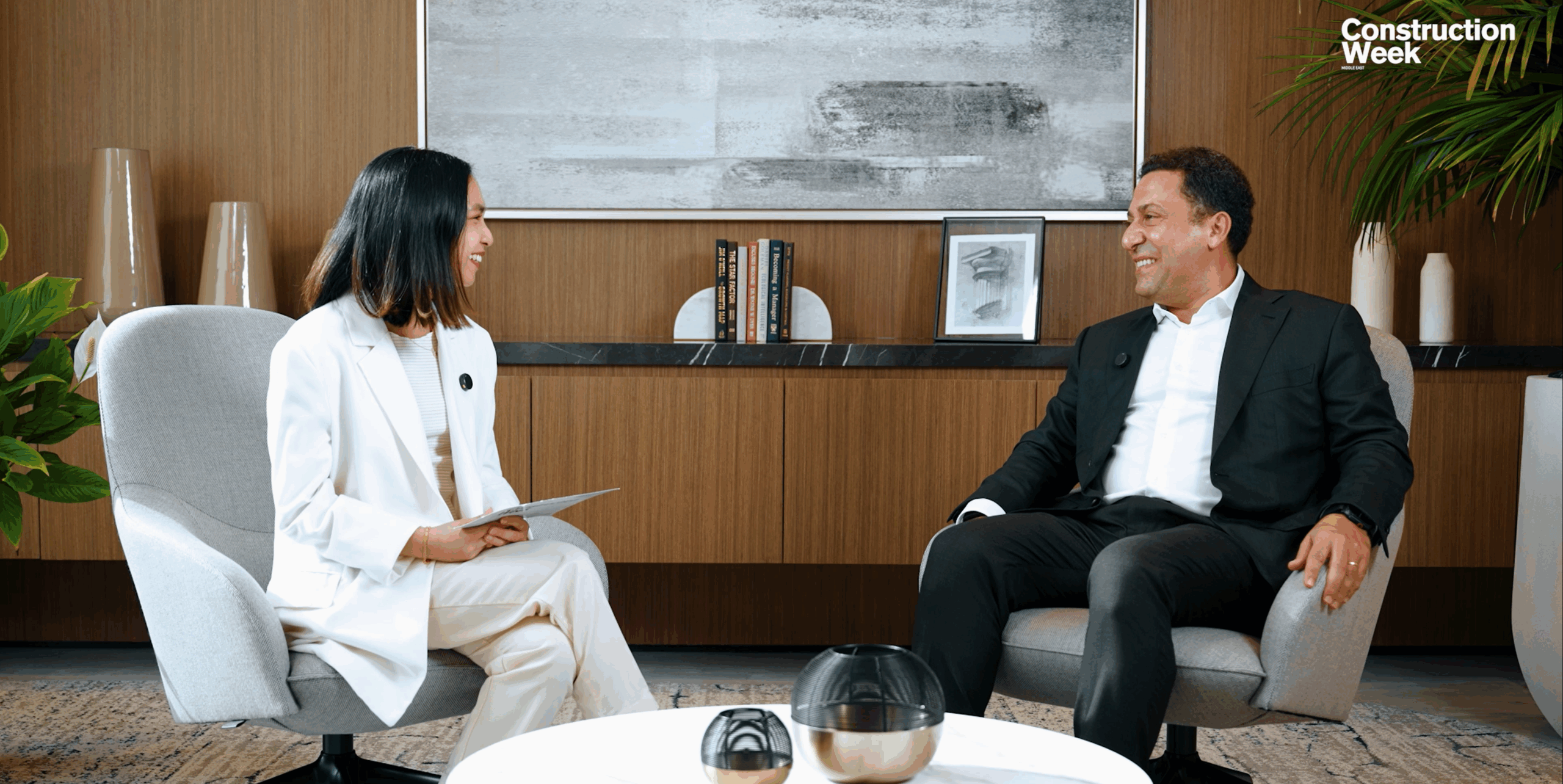 On-camera interview between two professionals discussing construction and industry insights.